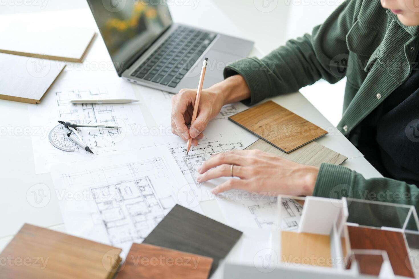 a man is working on a project with some architectural plans photo