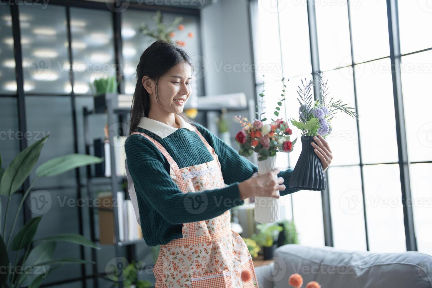 asian woman arranging flowers in vase photo