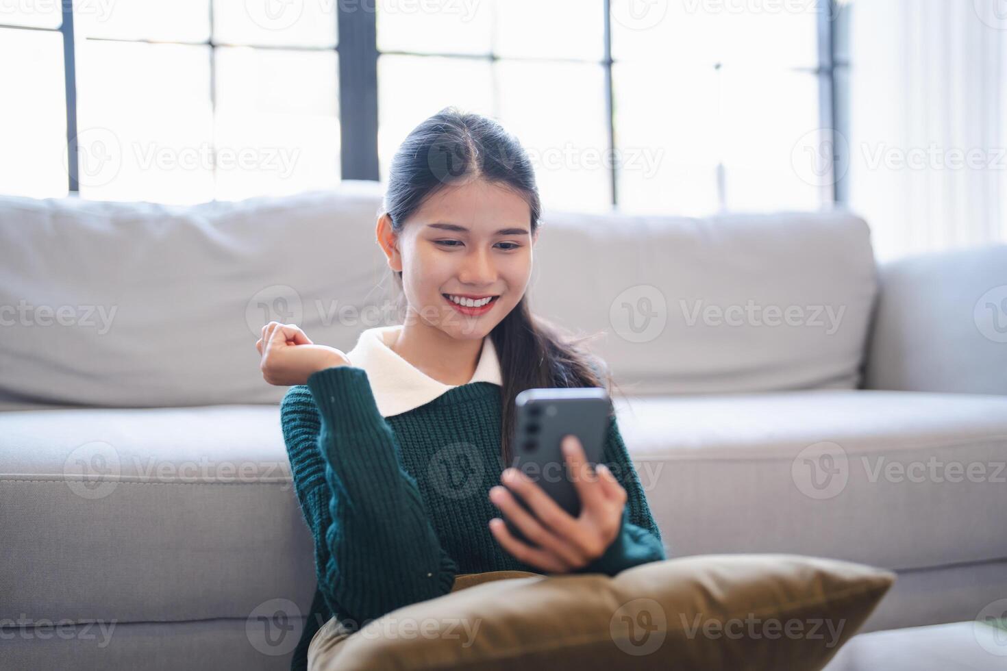 Young woman user customer hold smart phone Social media addiction with finger rings using online app on mobile phone browsing Internet chatting on social media. photo
