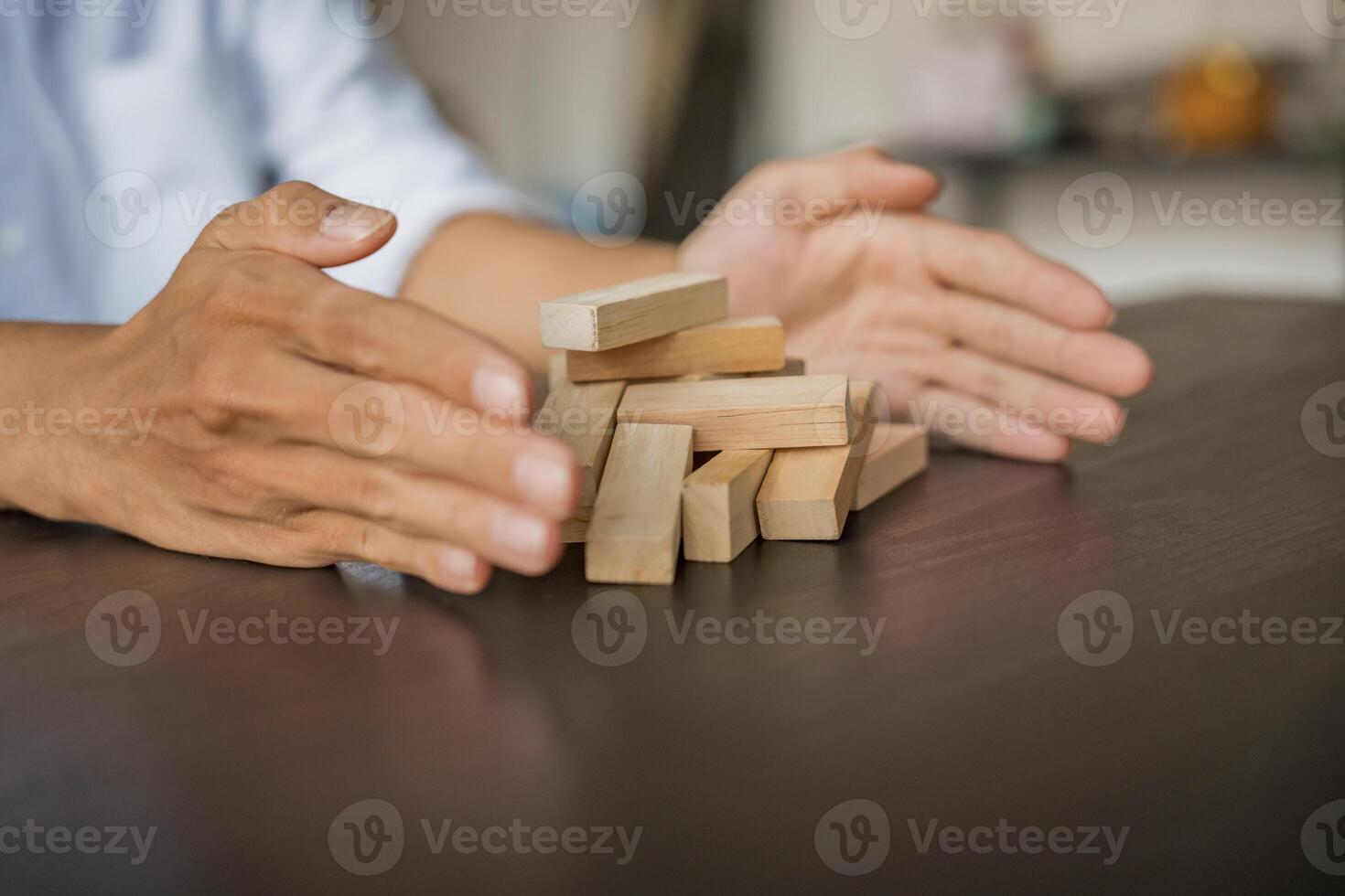 Planning risk and strategy in businessman gambling placing wooden block.Business concept photo