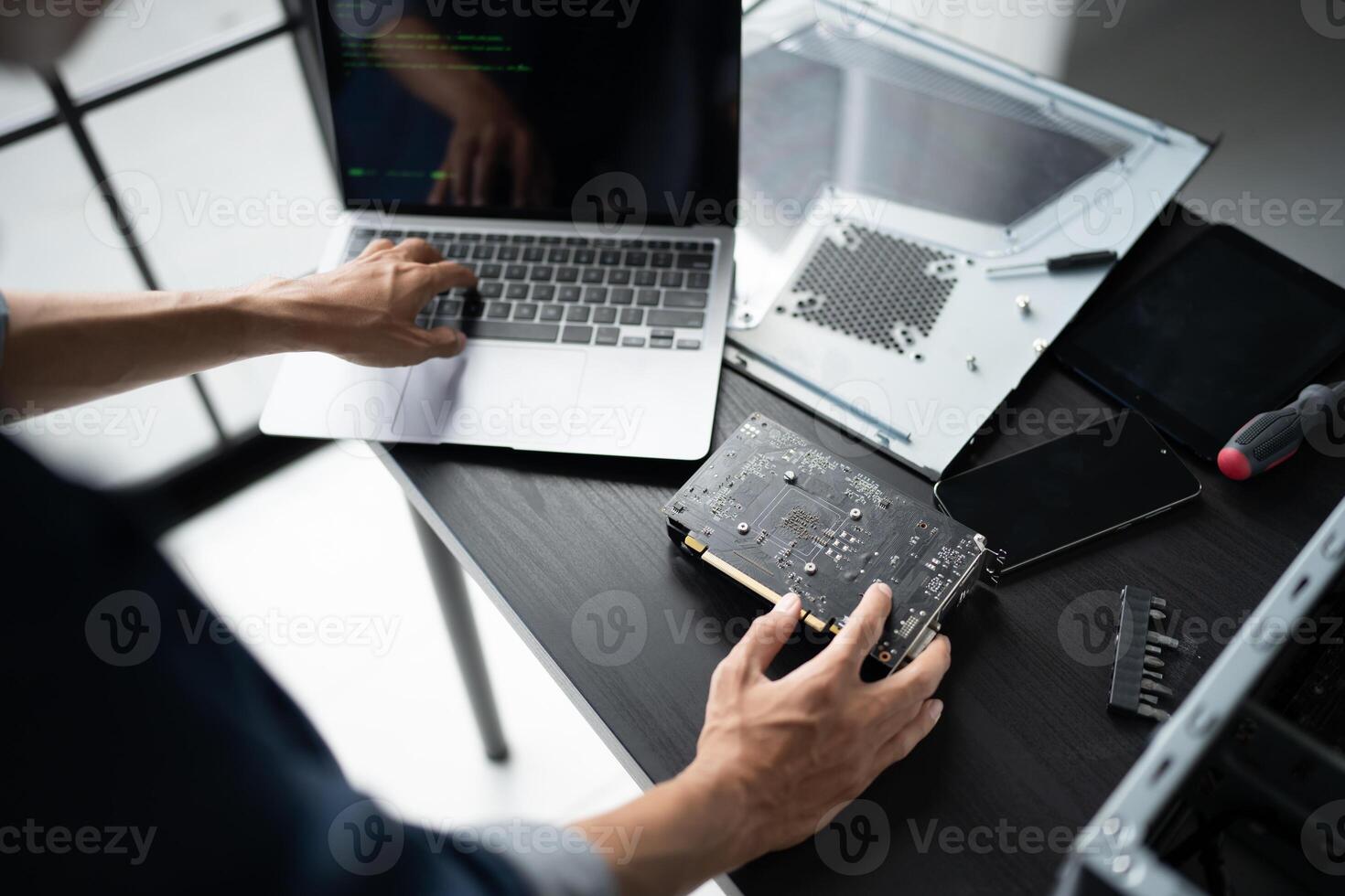 a person working on a laptop computer with a motherboard photo