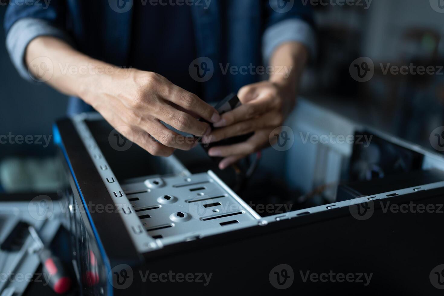 a man is fixing a computer case in room photo