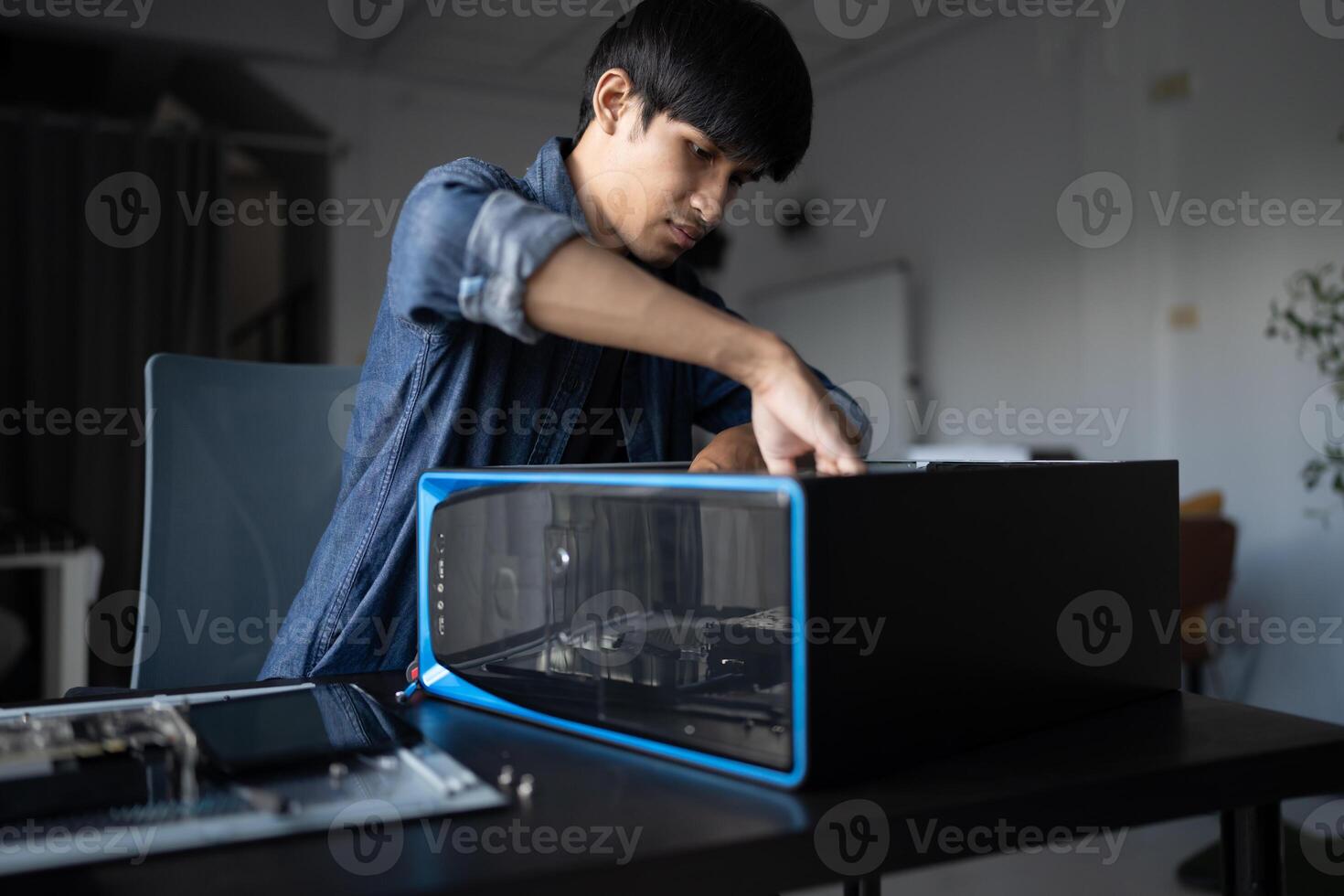 a man is working on a computer in a room photo