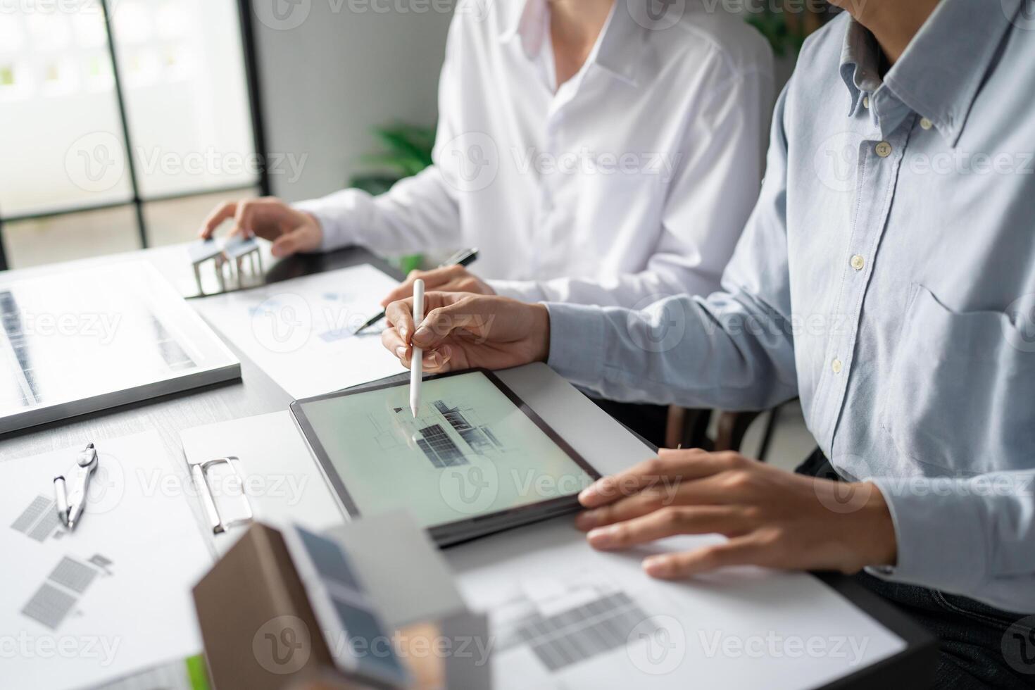 two people working on a project at a table photo