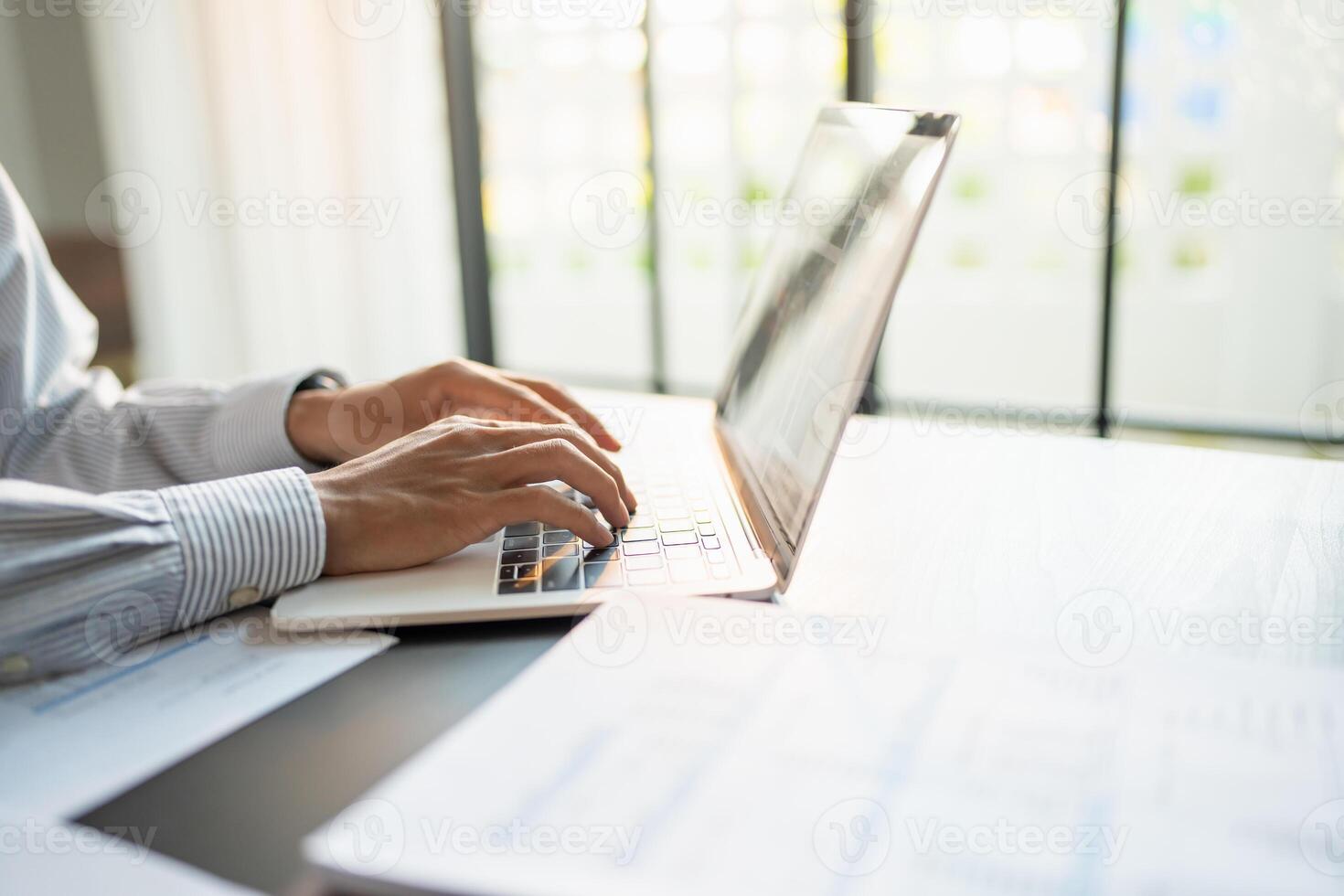 Businessman working using laptop computer Hands typing keyboard. Professional investor working start up project. business planning in office, Technology business photo