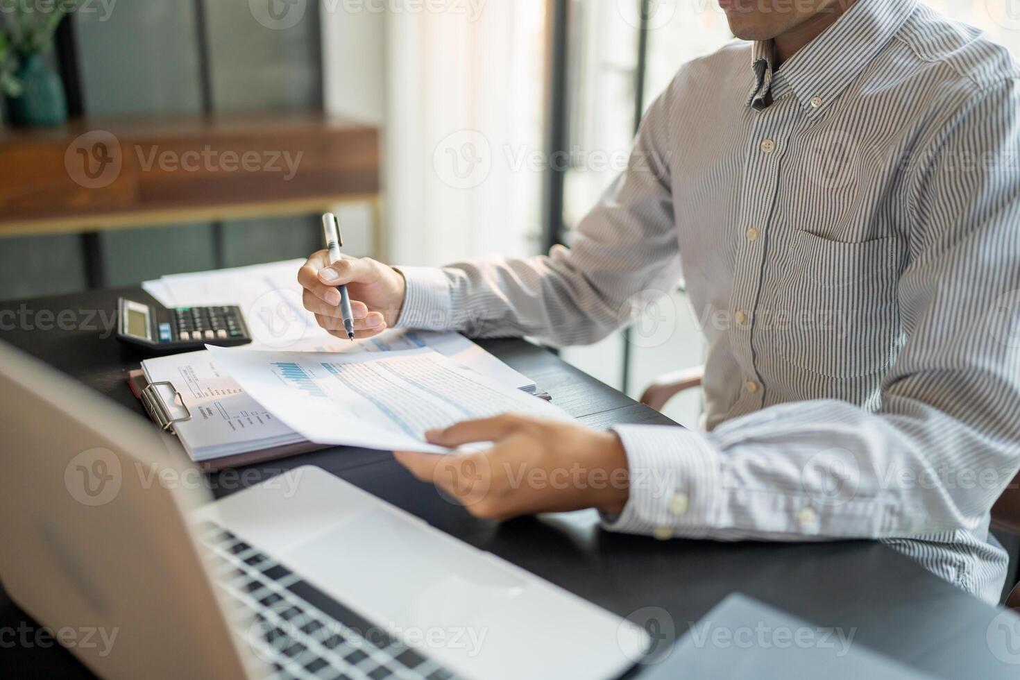 Close up of businessman hands signing writing document paperwork and report Auditor analysis male professional hand making notes with Business Document photo