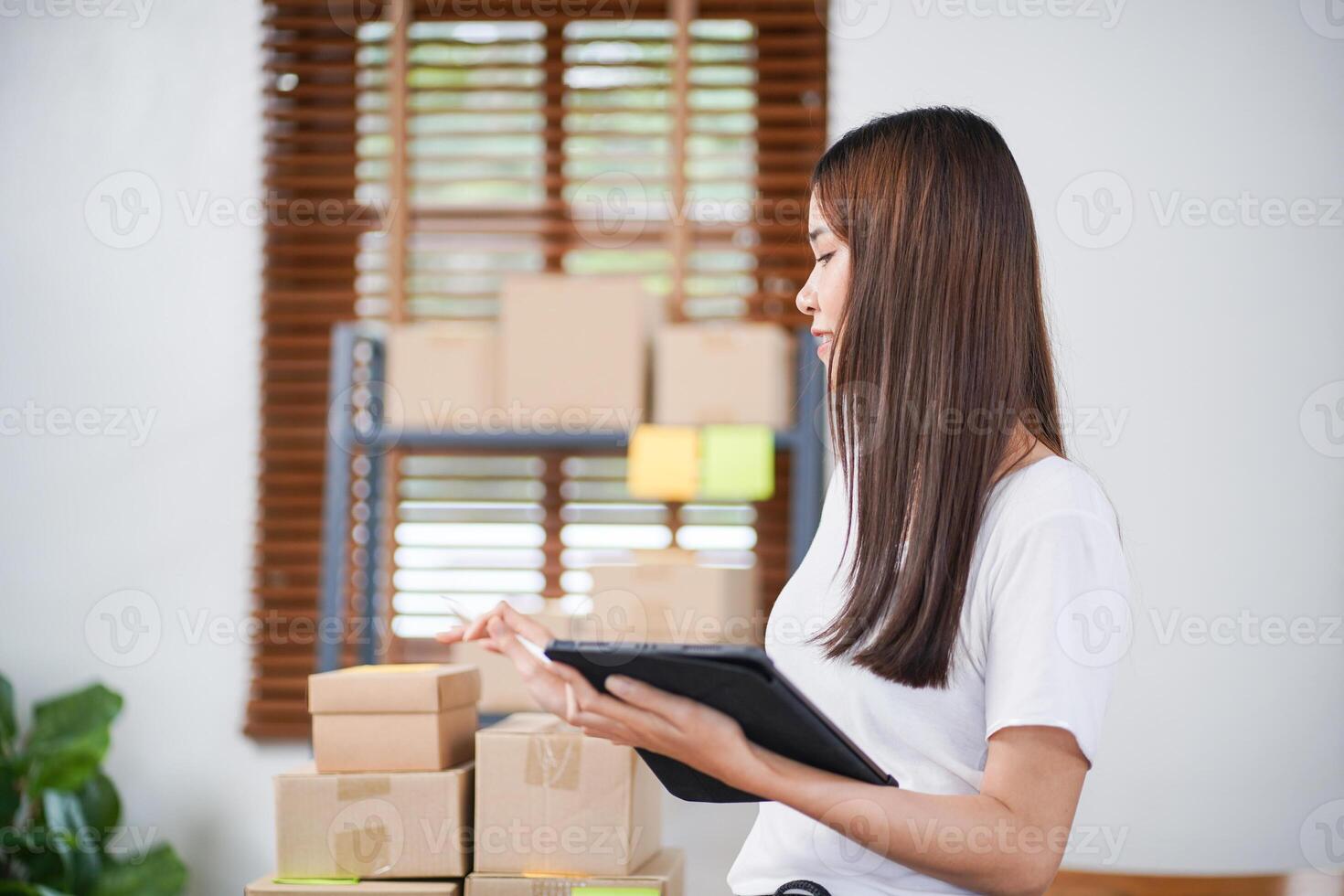 Asian woman preparing package delivery box Shipping for shopping online delivery mail service people and shipment concept. photo