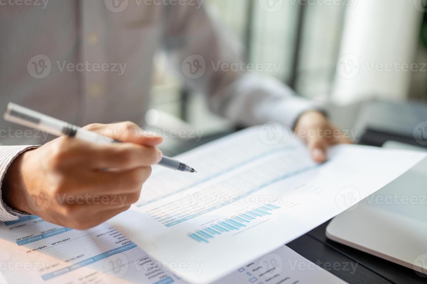 Close up of businessman hands signing or writing document paperwork and report Auditor analysis male professional hand making notes with Business Document photo