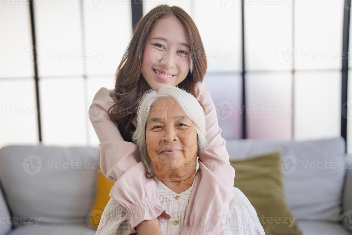 portrait of grandmother with granddaughter family leisure sits on couch at home. photo