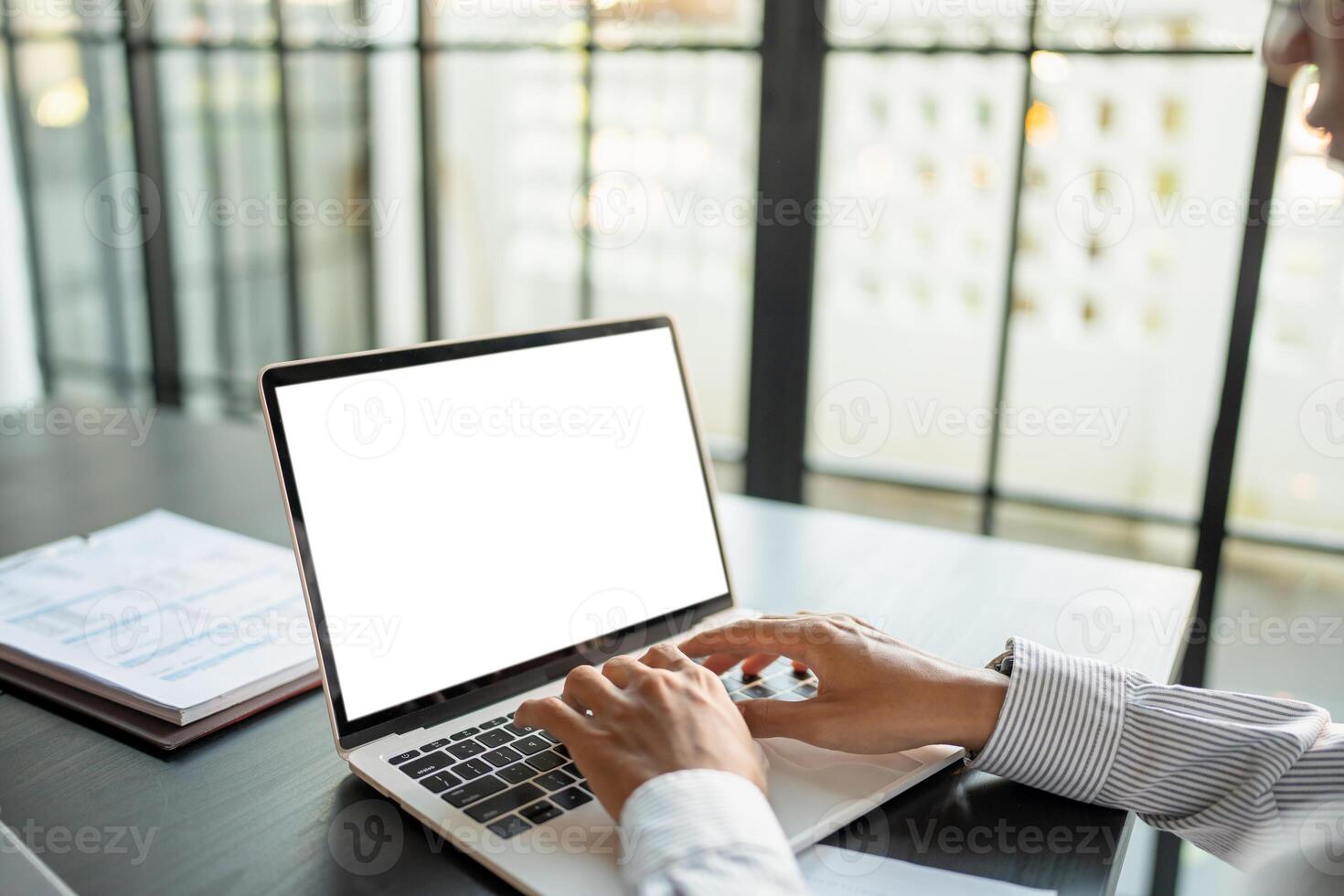 Business man using laptop blank screen computer working in office mockup blank screen computer white background. photo