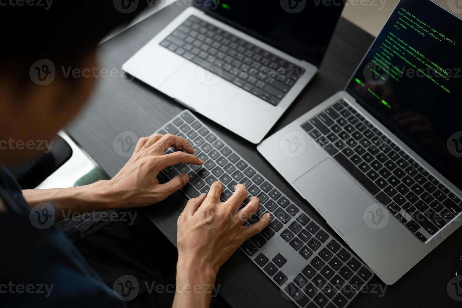Asian man software engineer Working on Computer at office desk for writing program code IT Software Engineer finding errors tech support creating digital photo