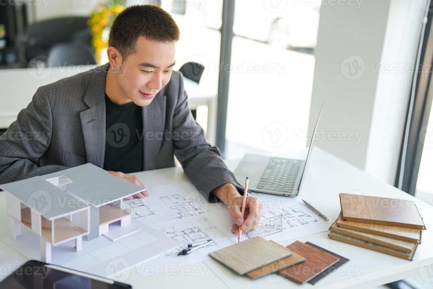 a man in a suit is working on a project. photo
