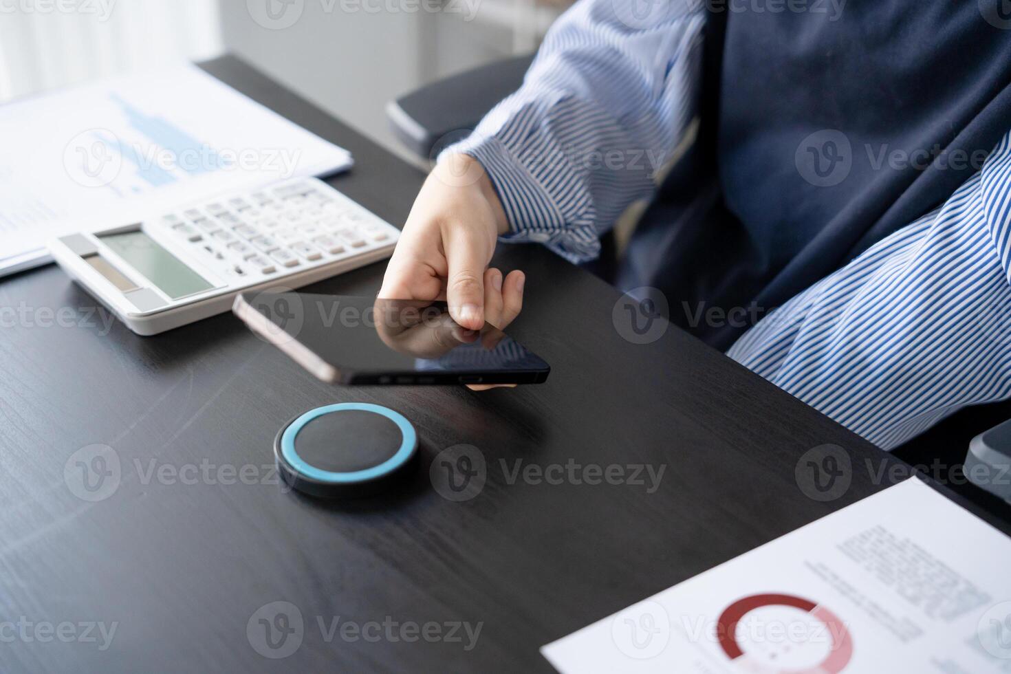 Woman charging smartphone by using magnetic wireless charger. photo