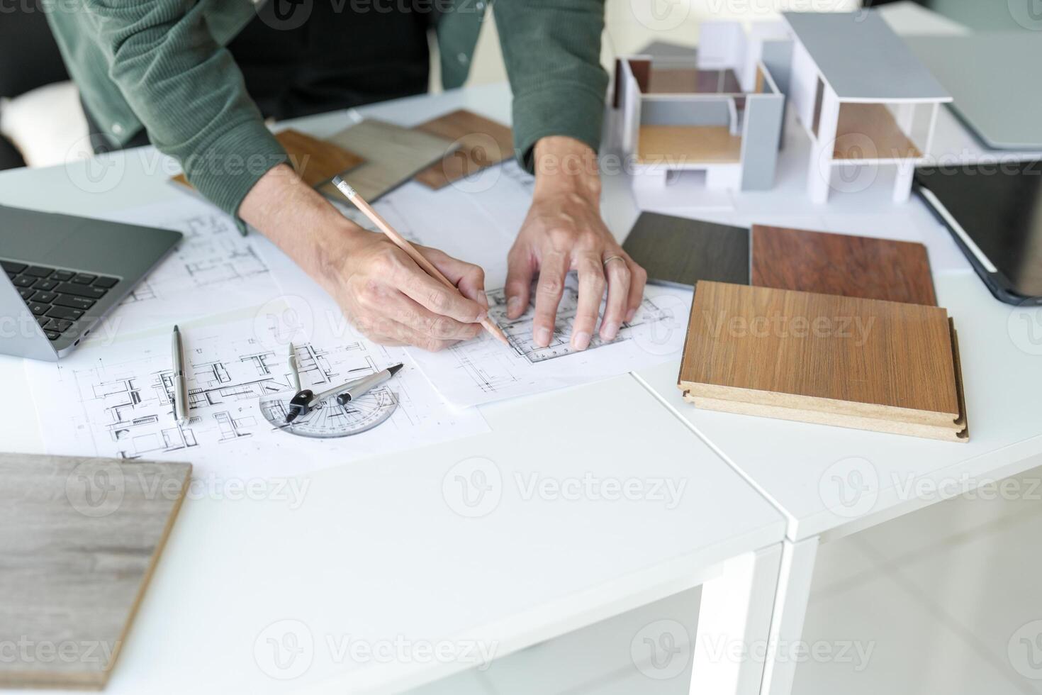 a person is working on a project with some architectural plans photo