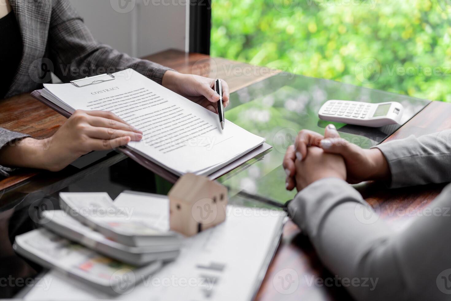 Business people signing contract making deal with real estate agent Concept for consultant home insuranceReal estate investment Property insurance security. photo