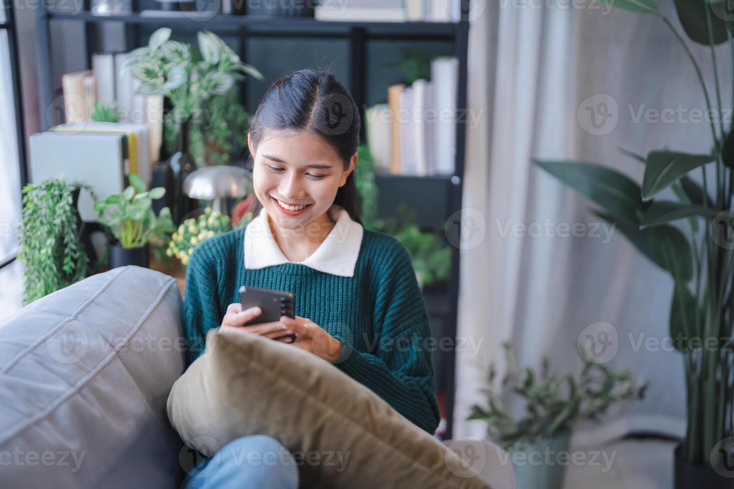 Asian woman using voice assistant on smartphone at home conversation with online assistant Voice chat bot conversational AI Modern Technologies. photo