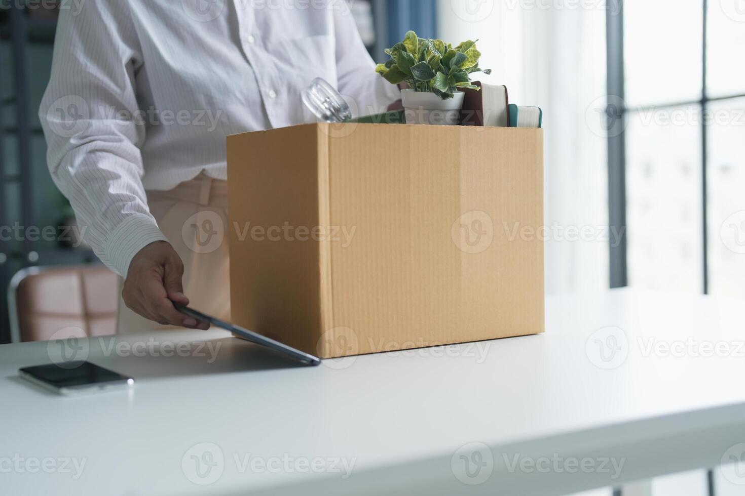 Quit Job senior asian business woman sending resignation letter and packing Stuff Resign Depress or carrying business cardboard box in office layoff from company. photo