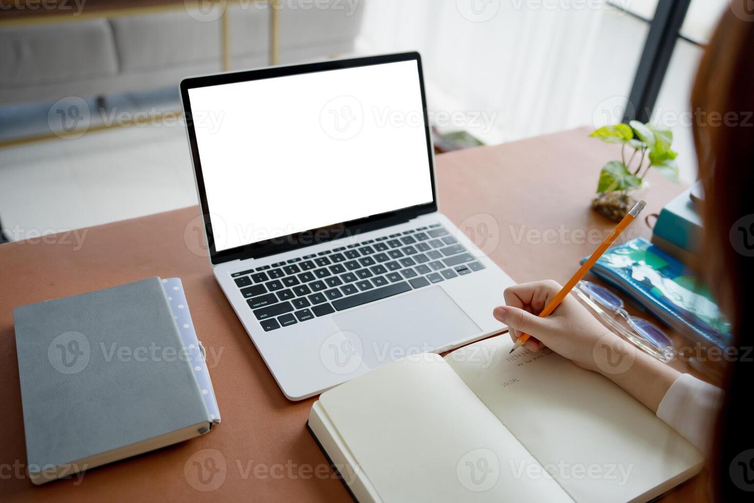 Students sitting at desk using laptop blank screen computer working in office mockup image blank screen computer white background photo