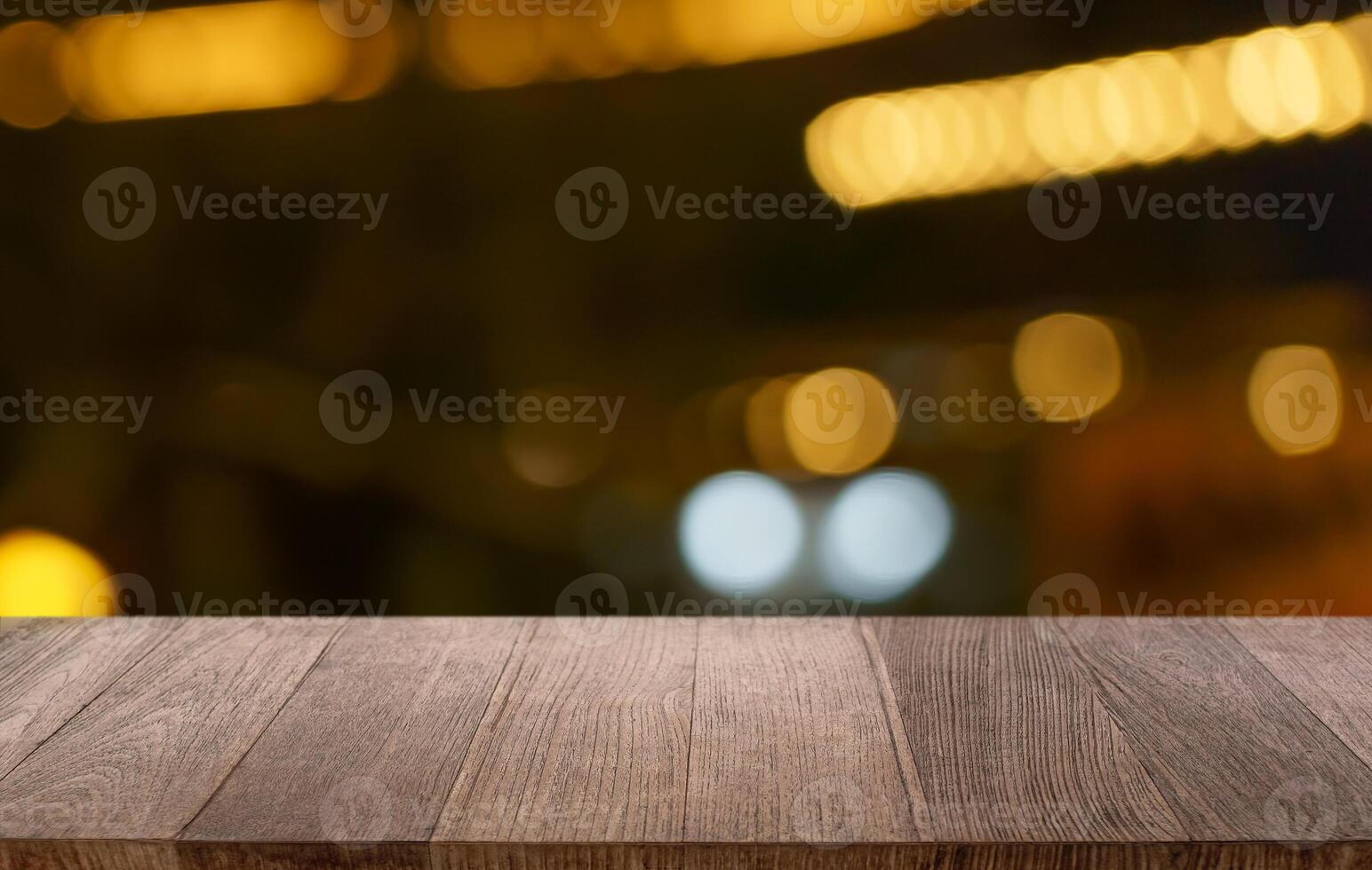 empty wooden table top on blurred background with bokeh lights photo