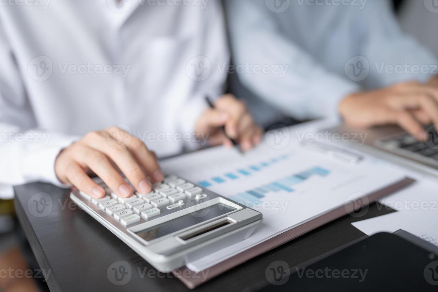 businessman using calculator to calculate the profit and loss statement photo