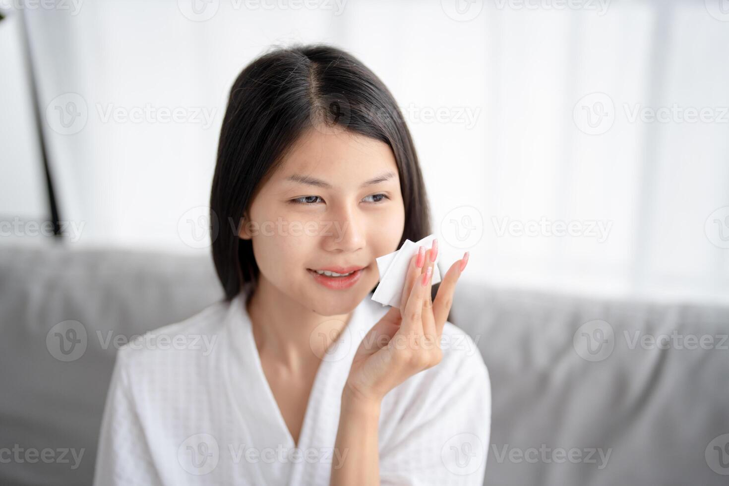 asian woman with white towel on her face photo
