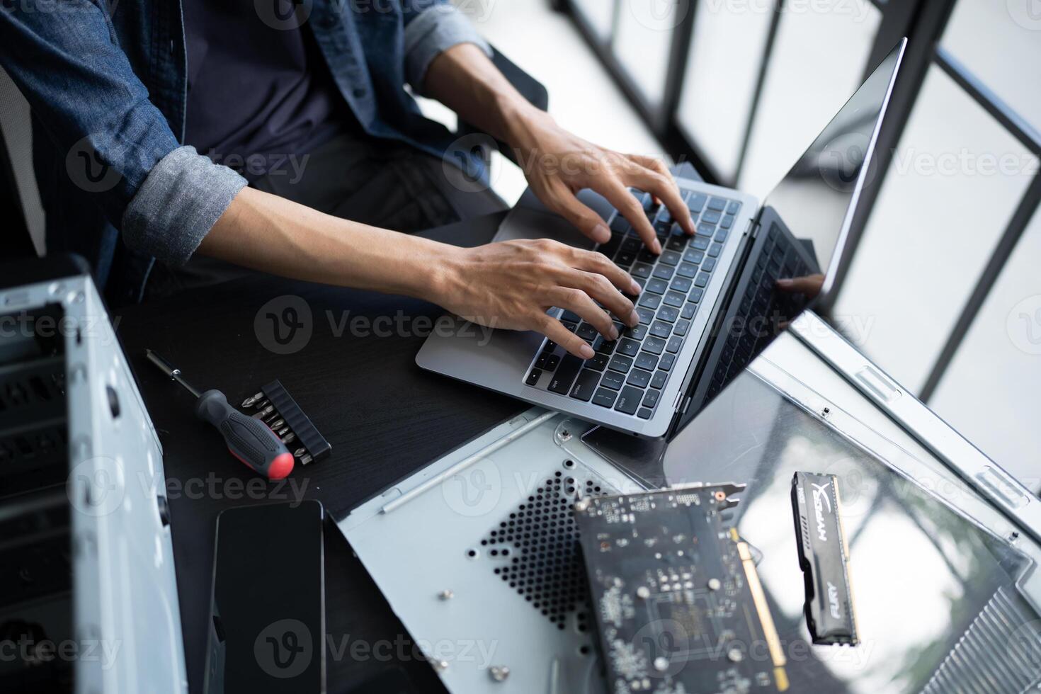 a person typing on a laptop computer fix on it photo