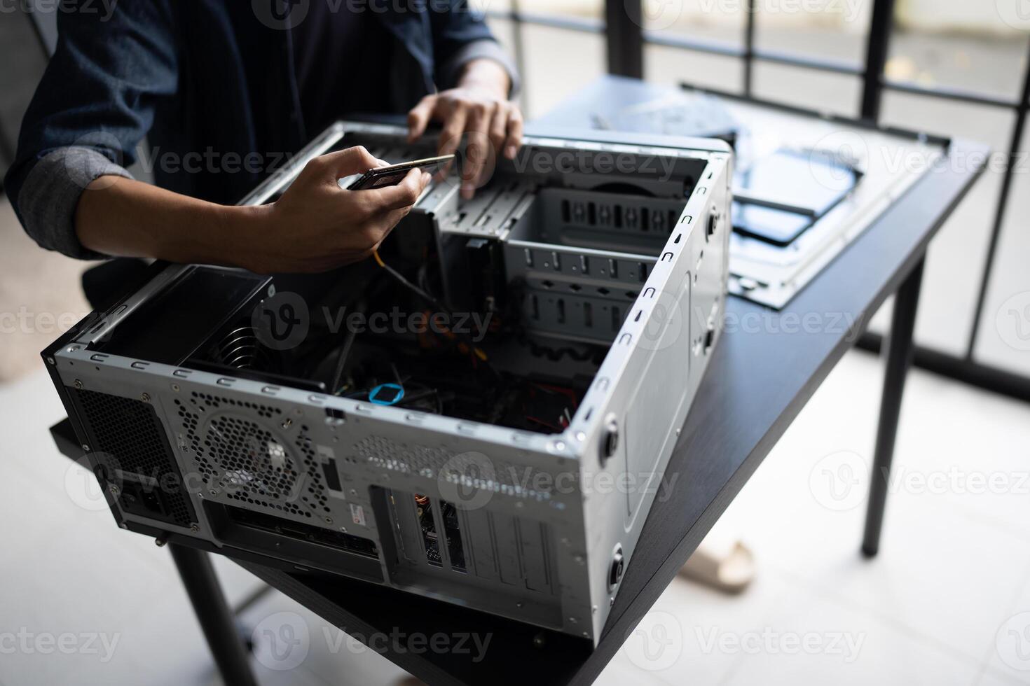 a man is working on a computer case photo