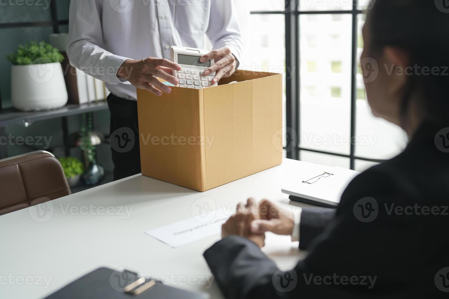 Business man sending resignation letter and packing Stuff Resign Depress or carrying business cardboard box Change of job or fired from company photo