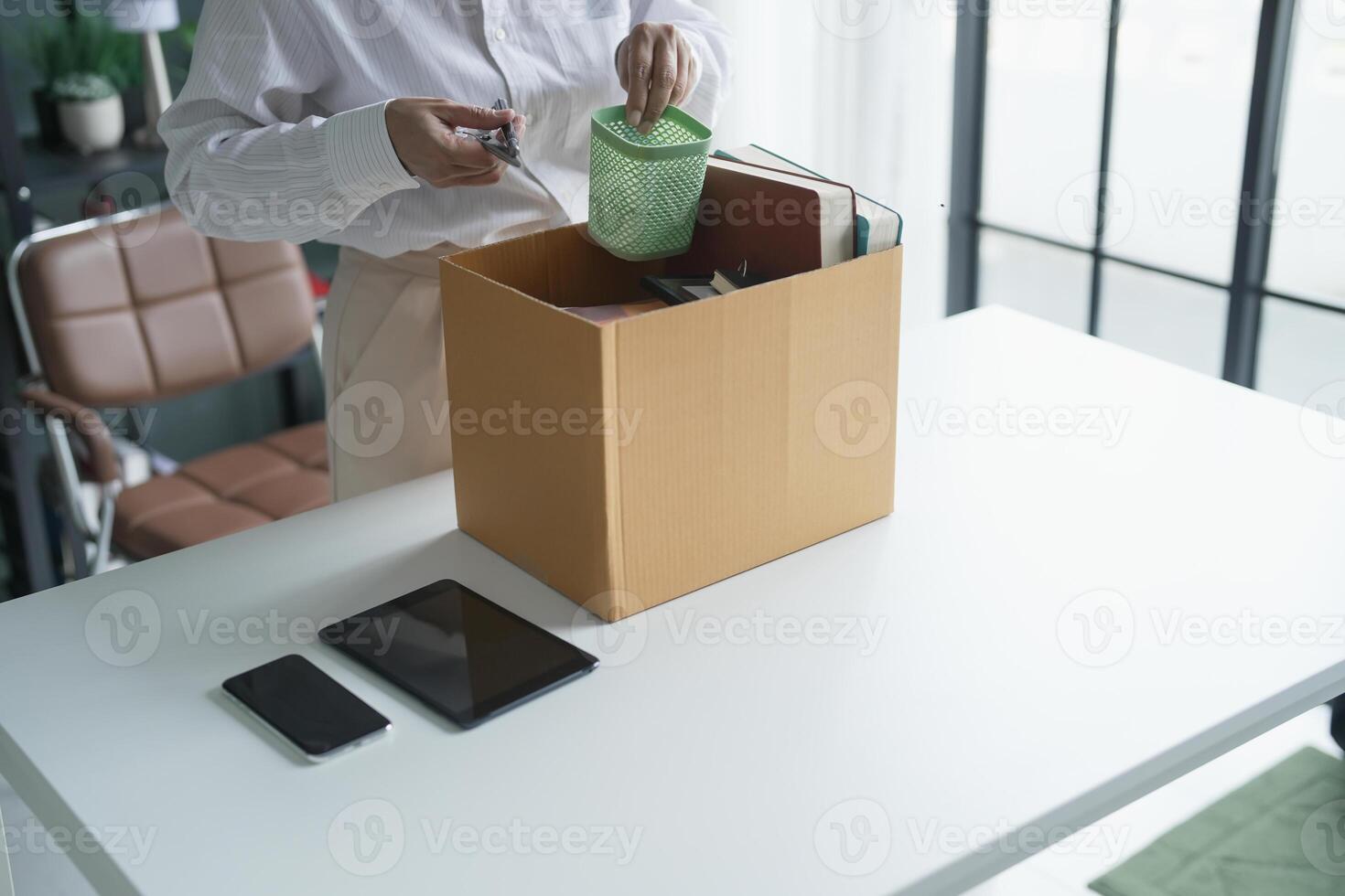 Quit Job senior asian business woman sending resignation letter and packing Stuff Resign Depress or carrying business cardboard box layoff retired from company photo