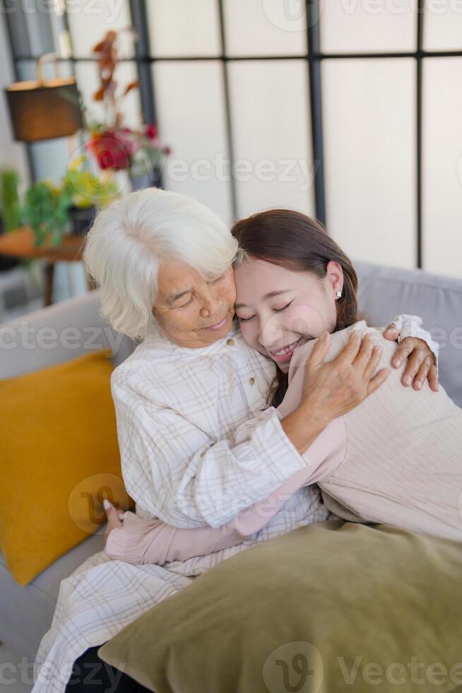 an older woman hugging a young woman. photo
