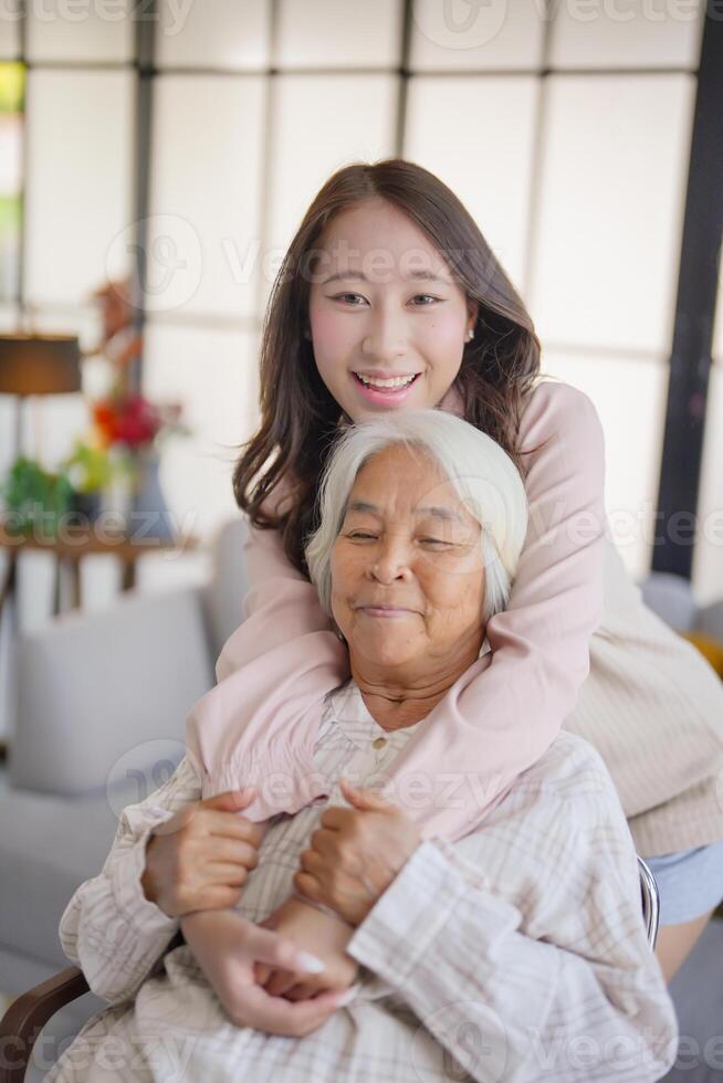 asian woman with her grandmother in the living room photo