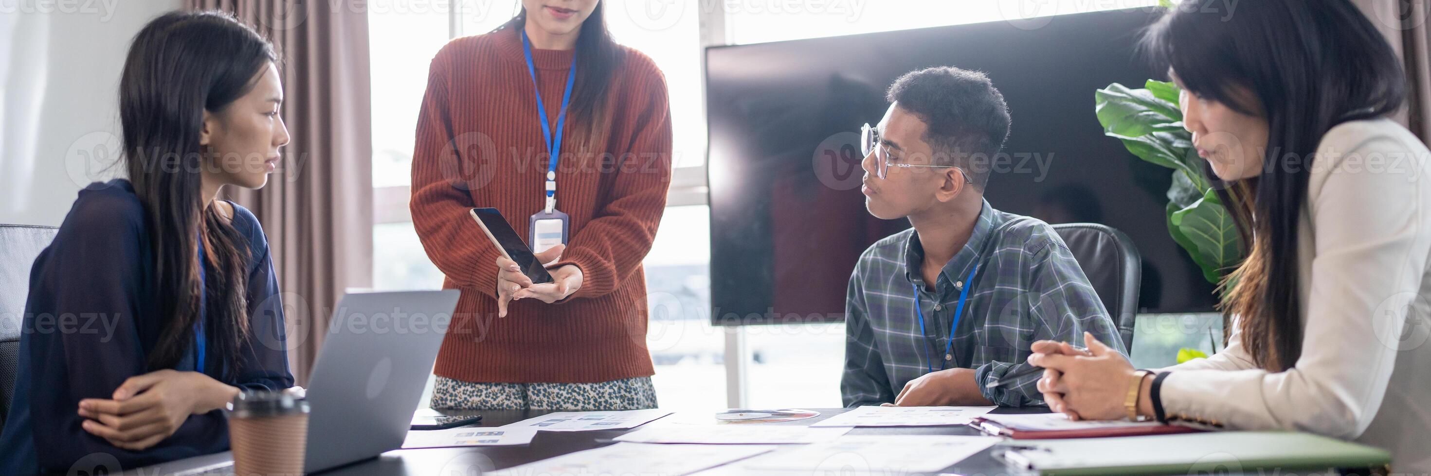 Asian business woman Application Designers presenting trending products report mobile application planning process development software design project ux. photo