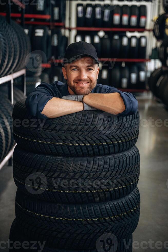 Inside of the wheels, having fun. Man ,,,,worker is maintenance station with tires photo