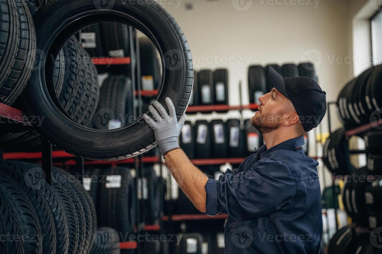 Bunch,, of tires, wheels. Man worker is maintenance station photo