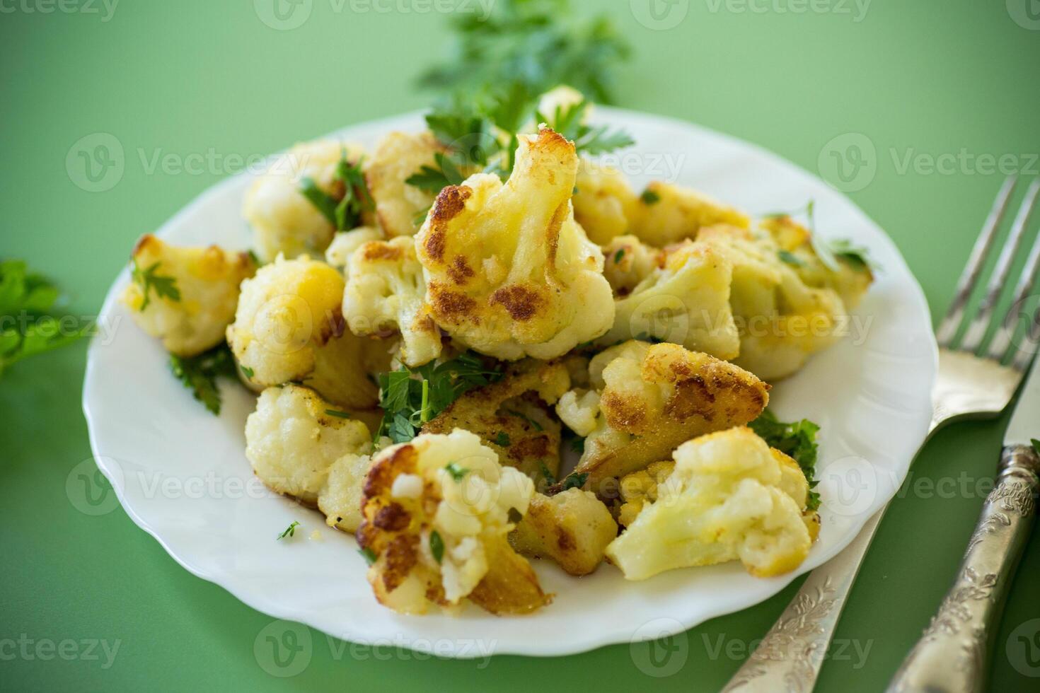 Rustic vegetable dish with cabbage and herbs on a green background photo