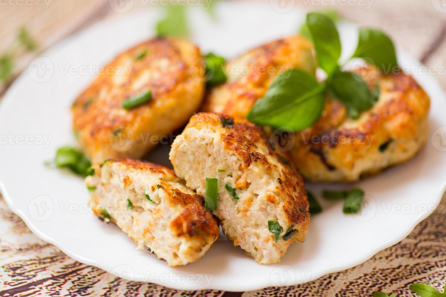 cooked chicken cutlets with herbs on a wooden table photo