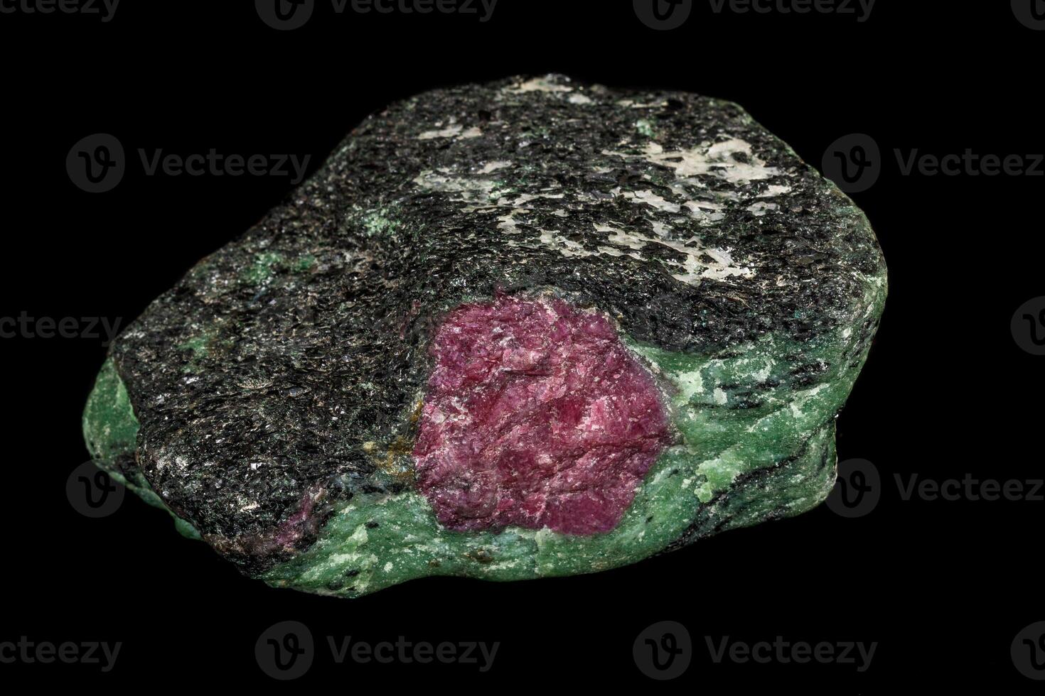 Macro of mineral, stone ruby, in rock on black background photo