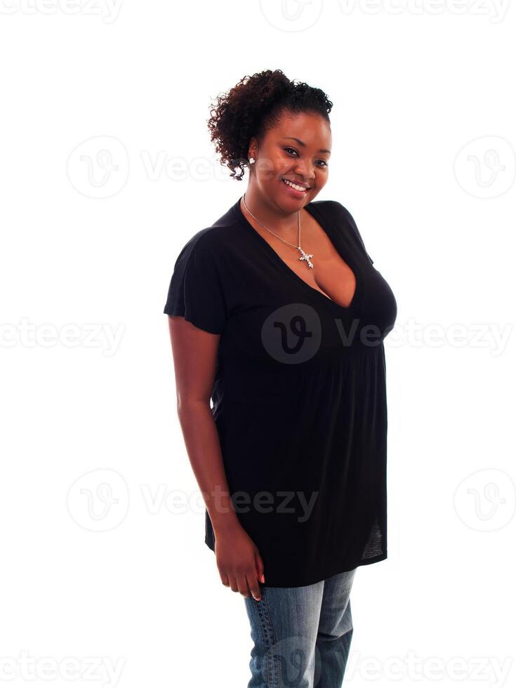 Smiling Plump African American Woman Standing In Black Top And Jeans photo