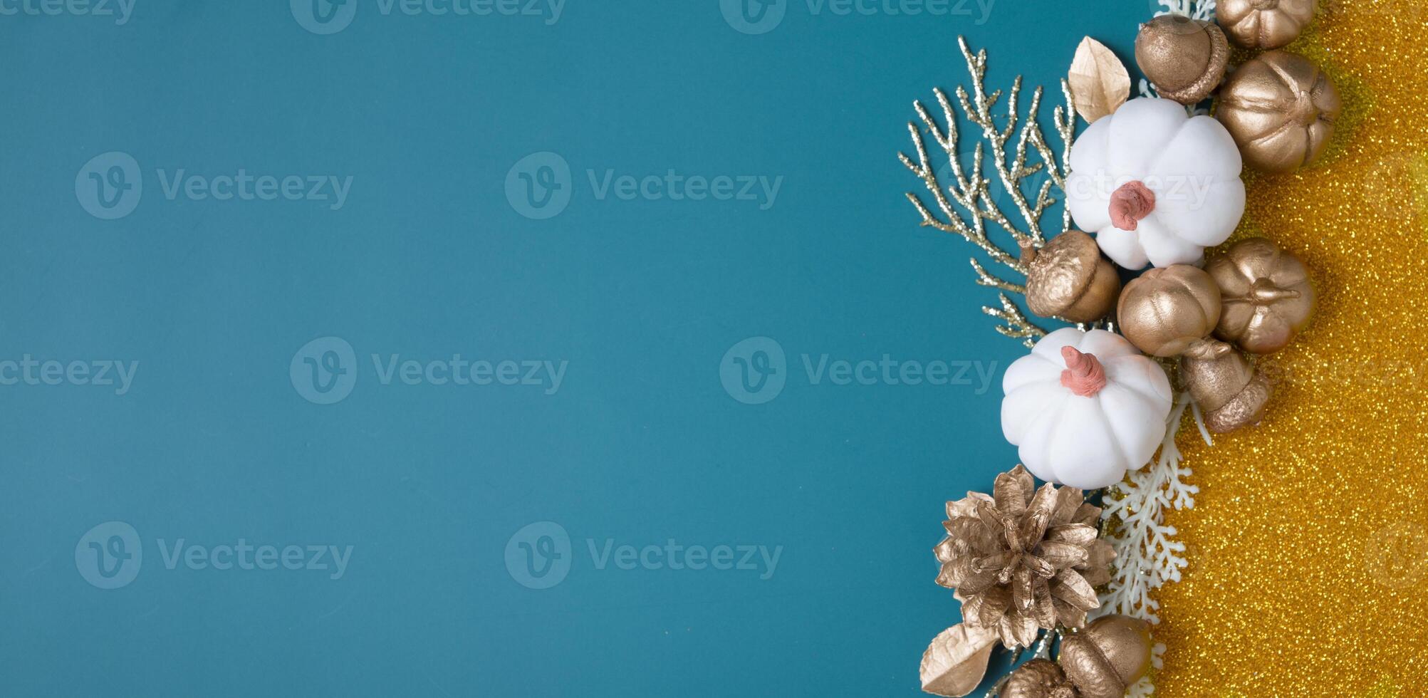 Abstract autumn banner background with golden pumpkins, leaves, acorns on colored paper backdrops with copy space photo
