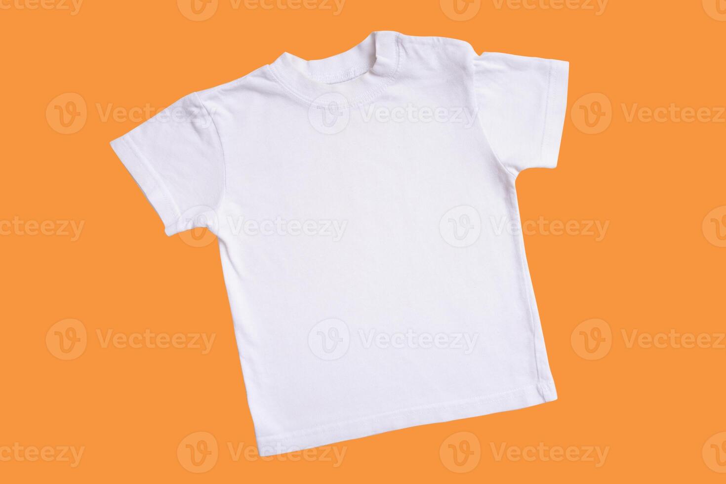 White children's t-shirt mockup for logo, text or design on wooden isolated on orange photo