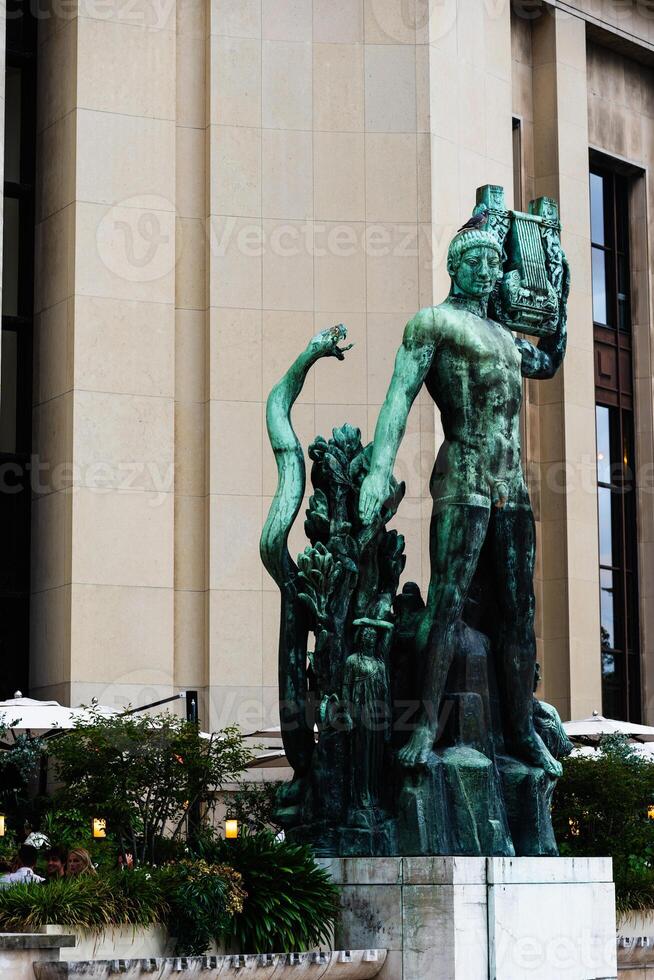Bronze Mythological Statue Outside Modern Building photo