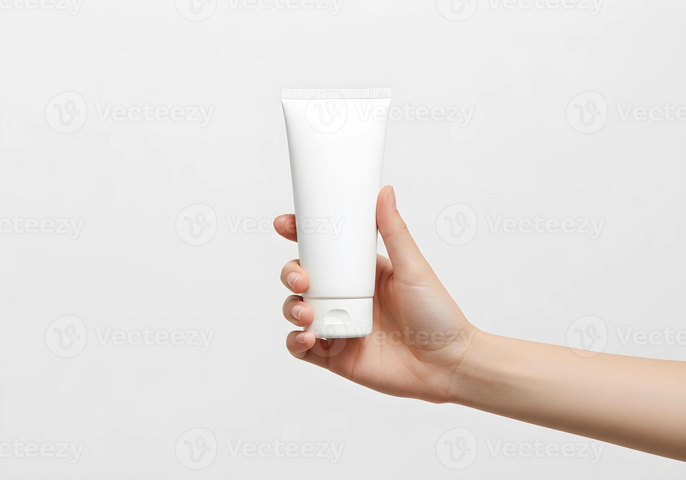 Hand Holding Blank Tube of Cream for Design Mockup 1 photo
