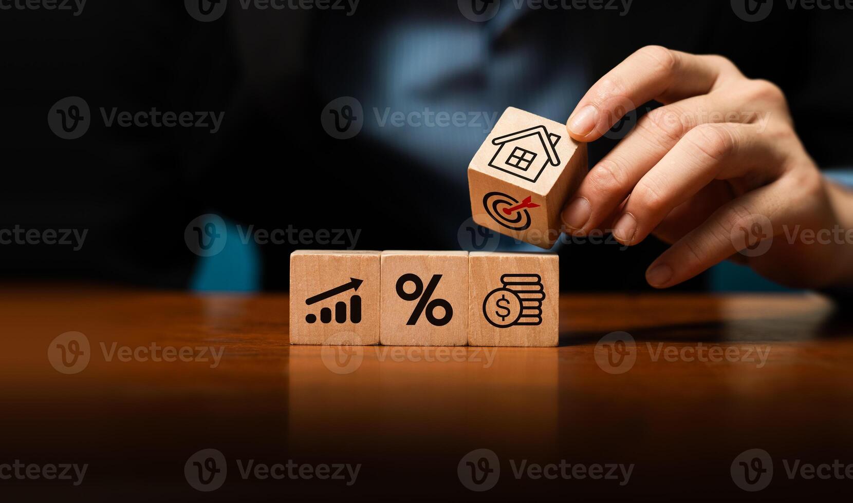 Real estate investment, financial planning, and business growth strategy concept with hand stacking wooden blocks. Property investment, mortgage rate, profit planning, and wealth management. photo