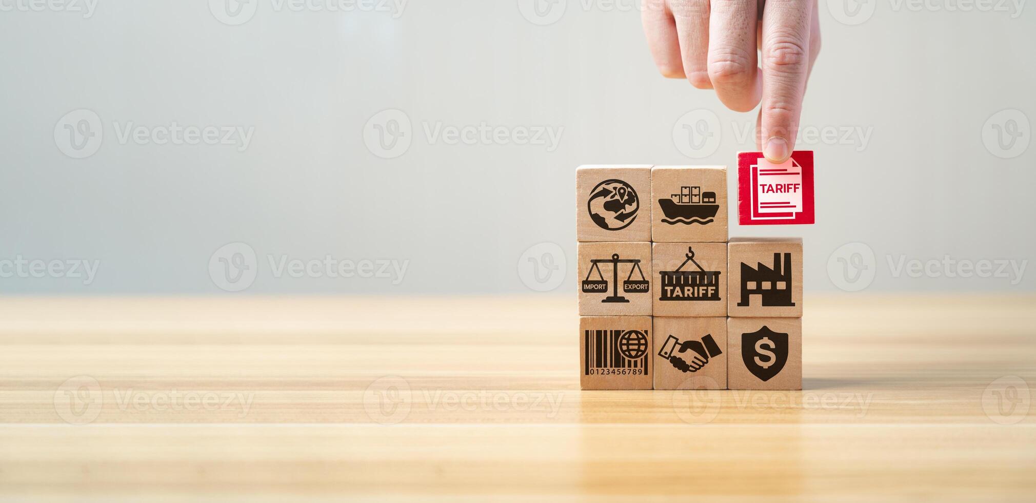 Tariff and international trade concept with wooden blocks showing import, export, shipping, factory, agreement, and tax symbols. Global commerce, customs duty, and economic regulation strategy. photo