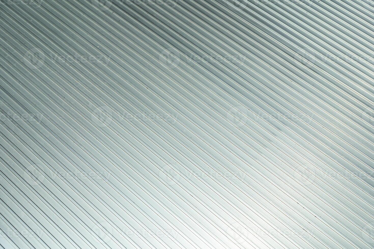 Modern metallic corrugated background with diagonal lines. Metallic plate texture with dust. photo