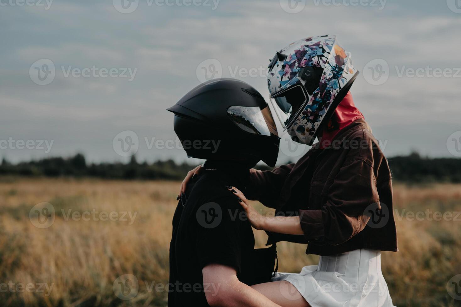 Couple of lovers kissing and hugging on motorbike photo