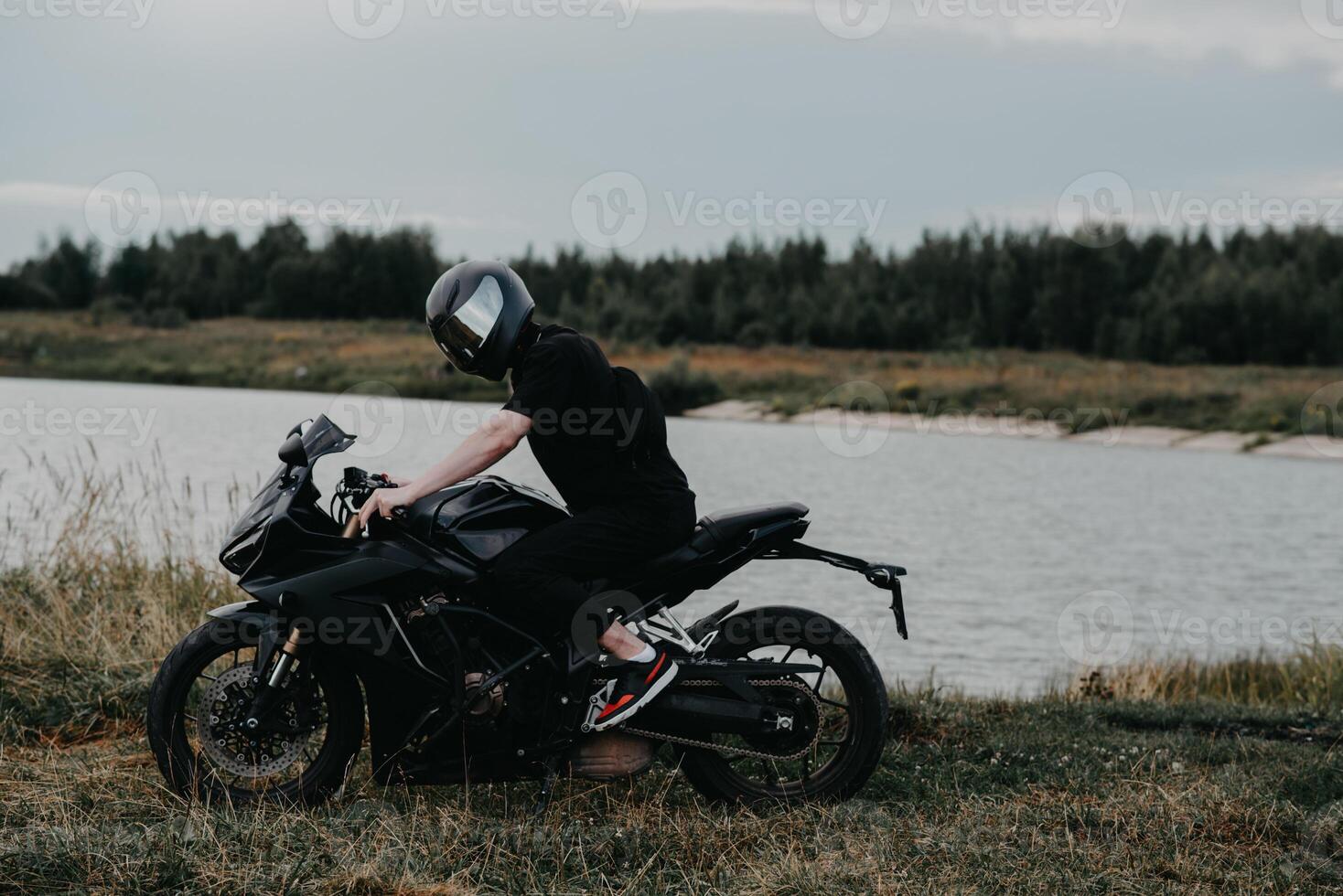 A young man is a biker on a sports motorcycle photo