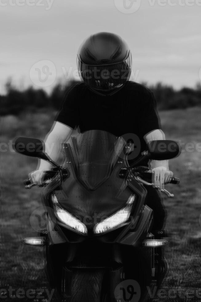 A motorcycle driver wearing a helmet is sitting on a sports motorcycle. The glitch effect photo