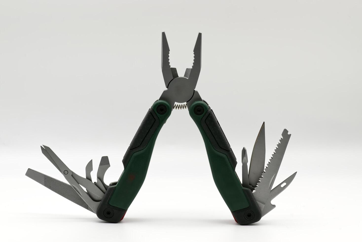 Multi tool with multiple functions and pliers isolated on white background. photo