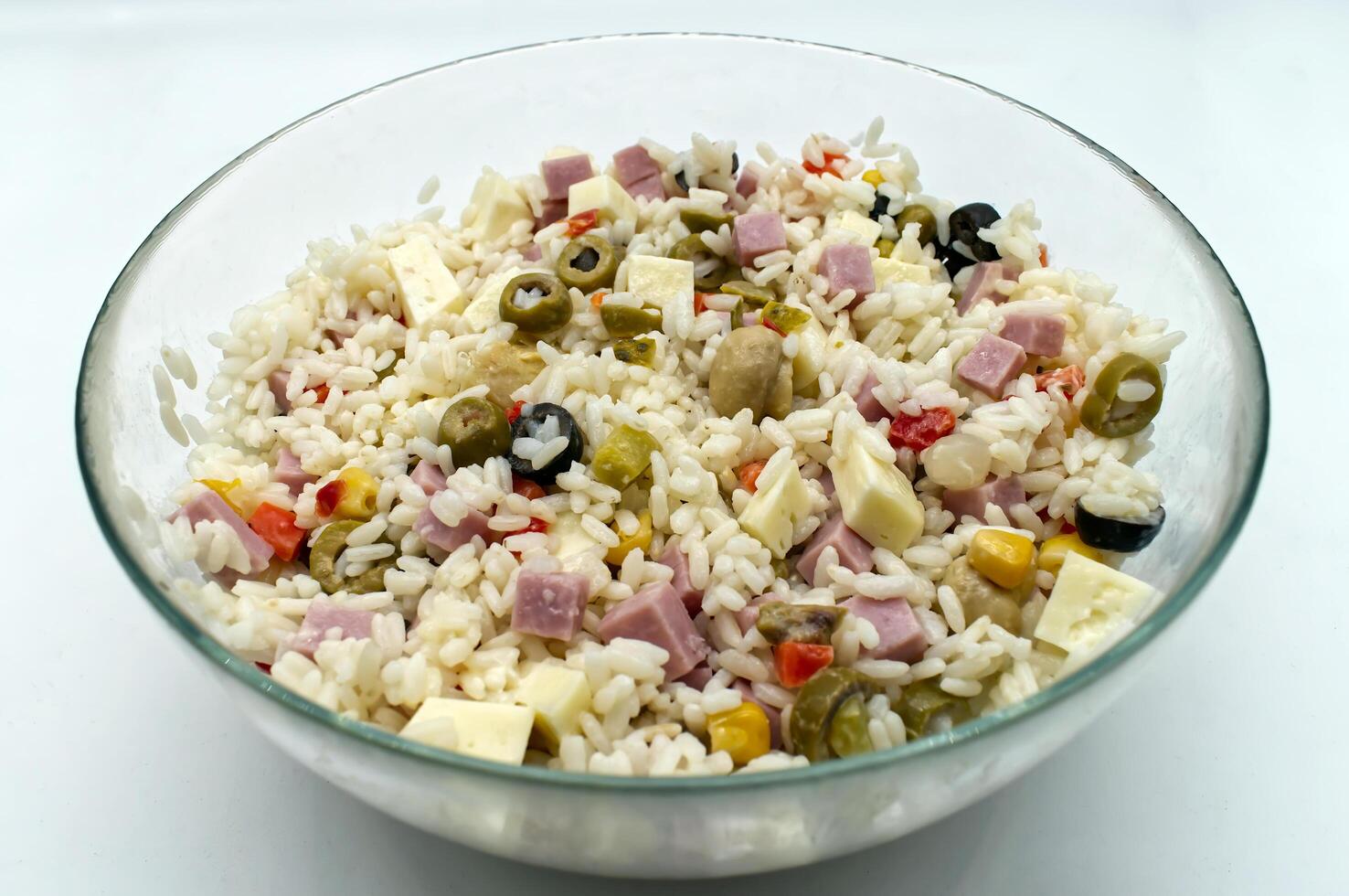 Delicious refreshing rice salad with cubed ham cheese and mixed vegetables for a summer lunch photo